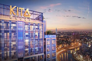A modern building with the sign "KITA GROUP" at the top. - Kotrip Luxstay Kieu By Kita Residence (Ho Chi Minh City)