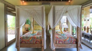 Two wooden four-poster beds with colorful bedding, a wooden ceiling, and a view of the outdoors. - Hibiscus/Upper Suite/Ubud/Pool/AC (Bali)