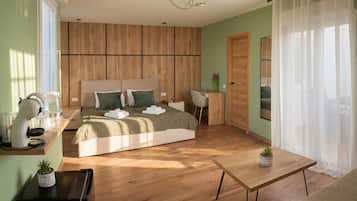 A modern bedroom with a bed, bedside table, and a desk with a chair.