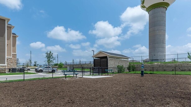 A large water tower with the text "sunfield" and a website address. - Landing | Incredible 2BD, Game Room, Gym (Buda)