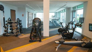 A gym with weight machines, treadmills, and stationary bikes. - Landing Apartments near Five Points South (Birmingham)