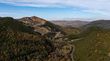 A mountainous landscape with a winding road and a valley.