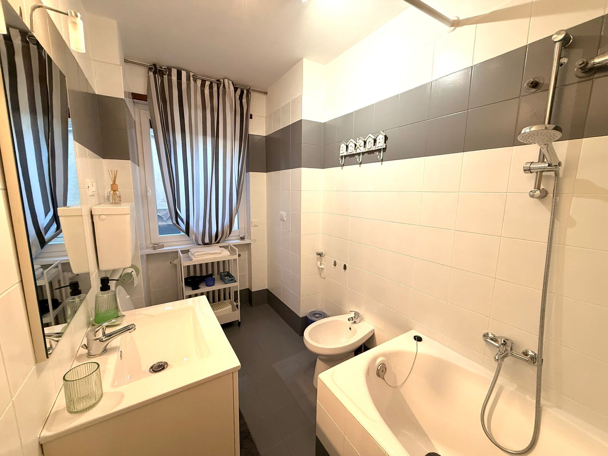 Une salle de bain moderne équipée d’une baignoire, d’une douche, d’un lavabo et de toilettes.