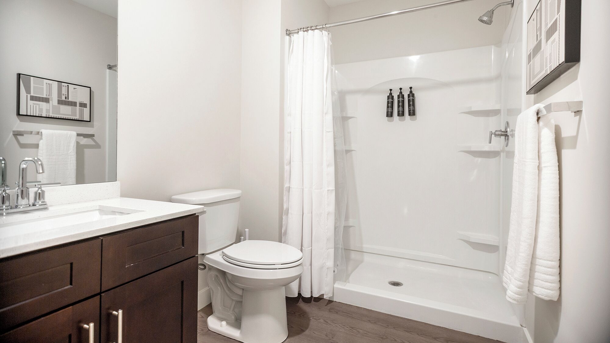 Une salle de bain moderne équipée de toilettes, d’un lavabo et d’une douche.