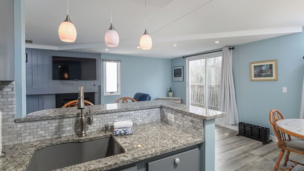 A kitchen with granite countertops, a sink, and pendant lighting. - Charming 2BR/2BA Bridge-Level Condo at The Bridges Resort (Warren)