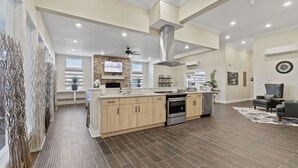 A spacious kitchen with a central island, built-in appliances, and a large window. - Landing | Amazing 2BD, Clubhouse, Gym (Loveland)