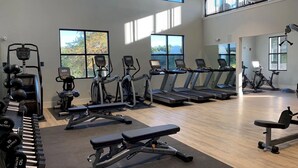 A gym with treadmills, elliptical machines, and free weights. - Landing Apartments West Windsor (Windsor)