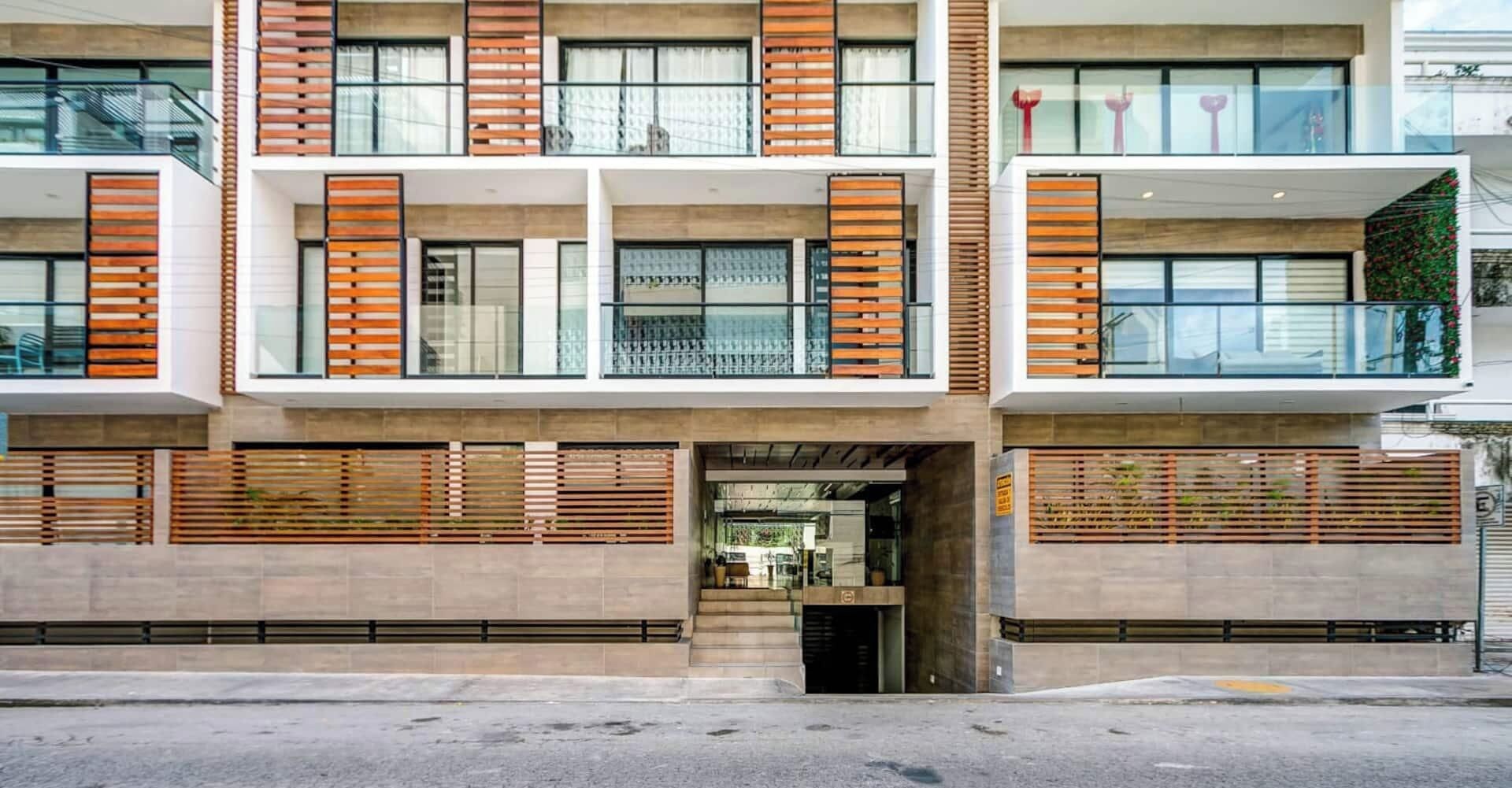 A modern multi-story building with a flat facade, large windows, and a central entrance.