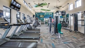 A gym with treadmills, weight machines, and a mirrored wall. - Landing | Spectacular 1BD, Pool, Gym (Houston)