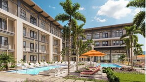 Un hotel con piscina, palmeras y mobiliario exterior.