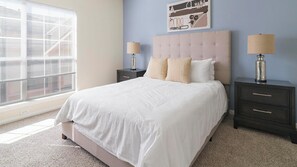 A bedroom with a large bed, two nightstands, a window with blinds, and a wall art piece. - Landing | Stylish 2BD, Gym, Clubhouse (Pasadena)