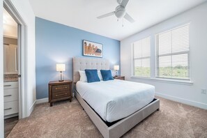 A bedroom with a bed, nightstands, a ceiling fan, and a window with blinds. - Landing | Incredible 2BD, Clubhouse, Gym (Vero Beach)