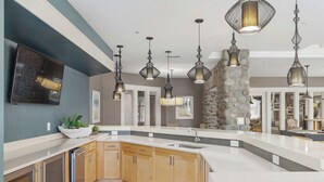 A modern kitchen with a large island, wooden cabinets, and pendant lighting. - Landing | Stunning 2BD, Gym, Clubhouse (Norfolk)