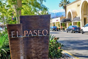 A wooden sign with the name 'EL PASEO' indicating a location or area. - Fabulous 2-bedroom condo with AC in sunny Palm Desert (Palm Desert)