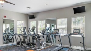 A gym with treadmills, stationary bikes, and a mirrored wall. - Landing | Chic 2BD, Gym, Clubhouse (North Port)