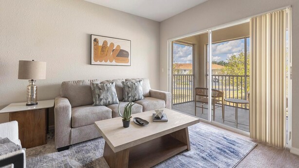 A living room with a sofa, a coffee table, a lamp, and a painting on the wall. - Landing | Modern 1BD, Courtyard, Gym (North Port)