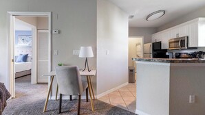 A modern apartment with a kitchen, dining area, and a bedroom. - Landing | Modern 1BD, Clubhouse, Gym (North Port)