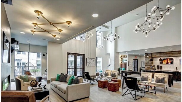 A spacious living area with a sofa set, a dining table, and a kitchen area. - Landing | Chic 1BD, Pool, Courtyard (Austin)