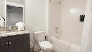 A bathroom with a toilet, sink, and bathtub. - Landing | Incredible 2BD, Clubhouse, Courtyard (Richmond)