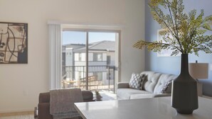A modern living room with a large window, a dining table, and a vase with flowers. - Landing | Modern 2BD, Pool (Casas Adobes)
