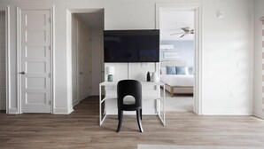 A room with a desk, chair, and a bed with a headboard. - Landing | Beautiful 2BD, Yoga Studio, Clubhouse (Johnstown)