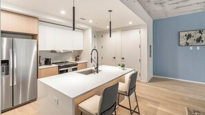 Fridge, dining tables - Landing | Chic 1BD, Gym, Yoga Studio (San Antonio)
