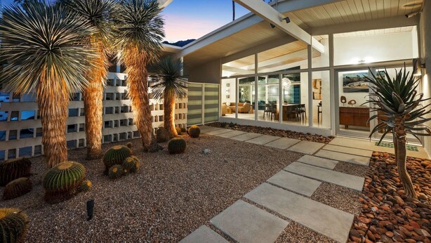 A modern building with a patio area featuring cacti and a stone pathway. - Central Palm Springs | Pool | Hot Tub (Palm Springs)