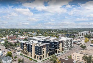 A multi-story building with a flat roof, surrounded by roads and other buildings. - Landing | Stylish 1BD, Clubhouse, Gym (Colorado Springs)