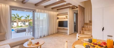 A modern living room with a pool view, a dining area with breakfast, and a staircase.