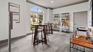 A modern kitchen with a round dining table, bar stools, and a built-in wine rack. - Landing | Stunning 1BD, Courtyard, Clubhouse (Austin)