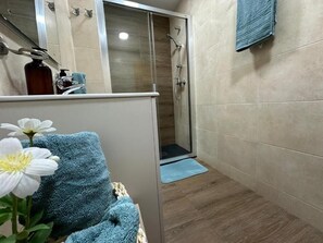 Shower, towels, soap, toilet paper