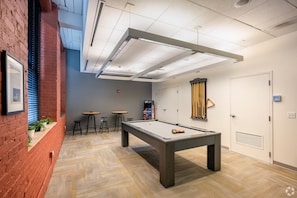 A pool table with stools, a ping pong table, and a door with a security panel. - Landing | Beautiful 1BD, Gym, Courtyard (New Haven)