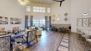 A spacious living room with a sofa set, a dining area with chairs, and a kitchen in the background. - Landing | Stunning 2BD in Corinth (Denton)