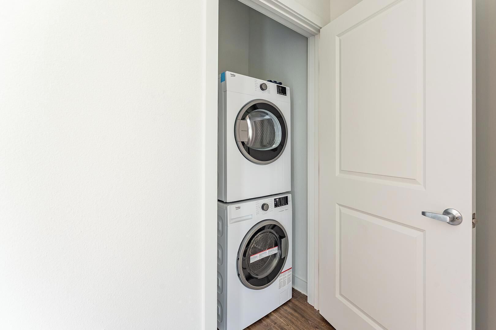 A laundry room with two stacked front-loading washing machines.