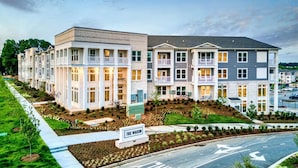 A multi-story residential building with a sign reading "THE MASON."