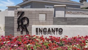 A building with a sign that reads "ENCANTO" and a large number "70" on the facade. - Landing | Stylish 1BD, Gym (Phoenix)