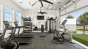 A gym with treadmills, elliptical machines, and free weights. - Landing | Stylish 1BD, Gym (Phoenix)