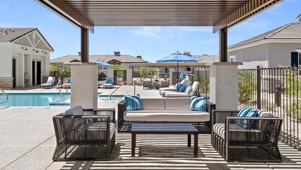 A covered outdoor area with a pool, lounge chairs, and umbrellas. - Landing | Stylish 1BD, Gym (Phoenix)