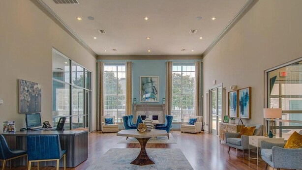 A spacious living room with a fireplace, large windows, and a modern seating arrangement. - Landing | Modern 1BD, Clubhouse, Gym (Murfreesboro)