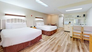 A hotel room with two beds, a kitchenette, and a seating area. - Inviting & Cozy Studio, Sleep 4, Shared Gym & Games (Baneberry)