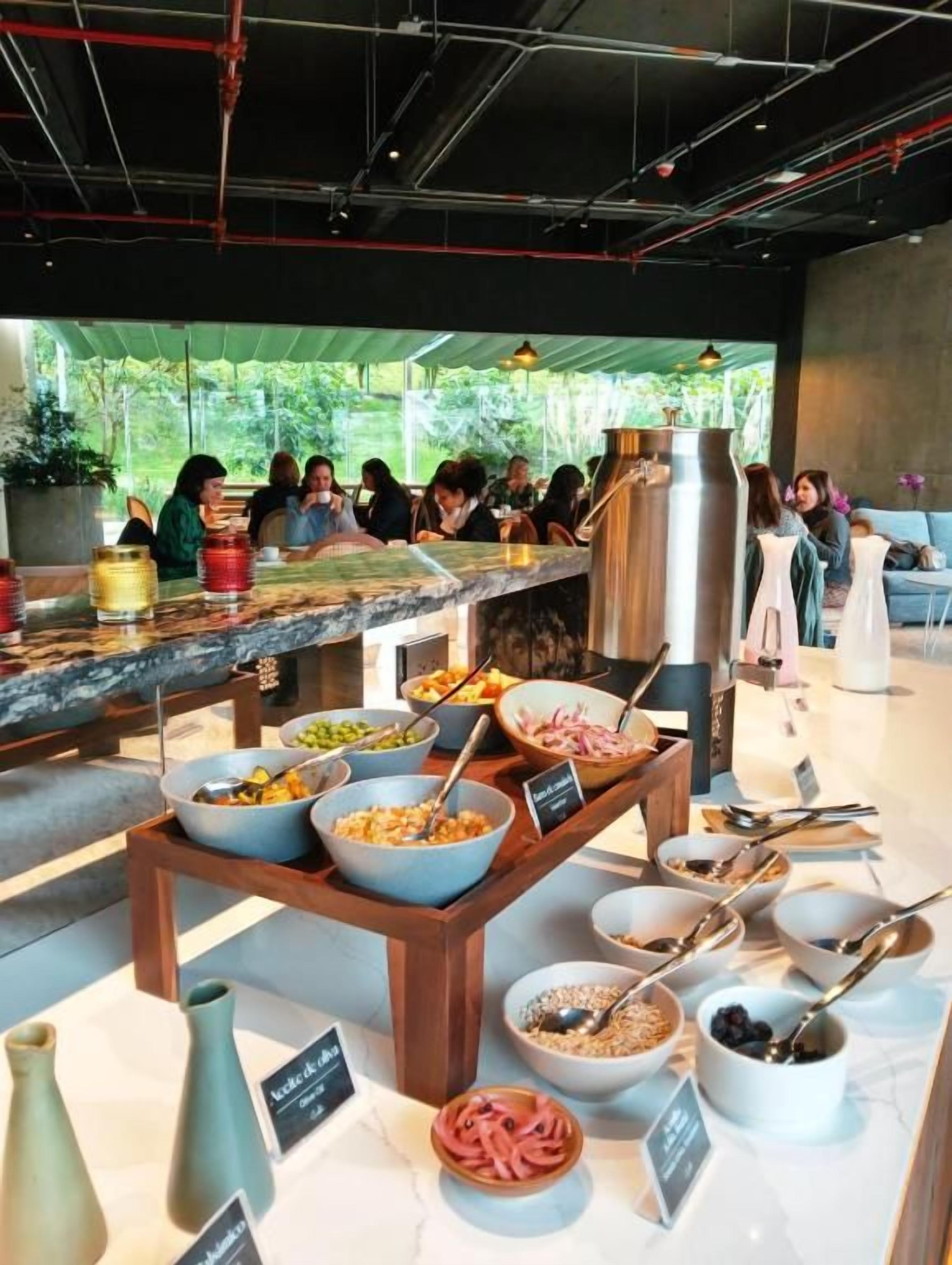 A buffet area with various food items and serving utensils.
