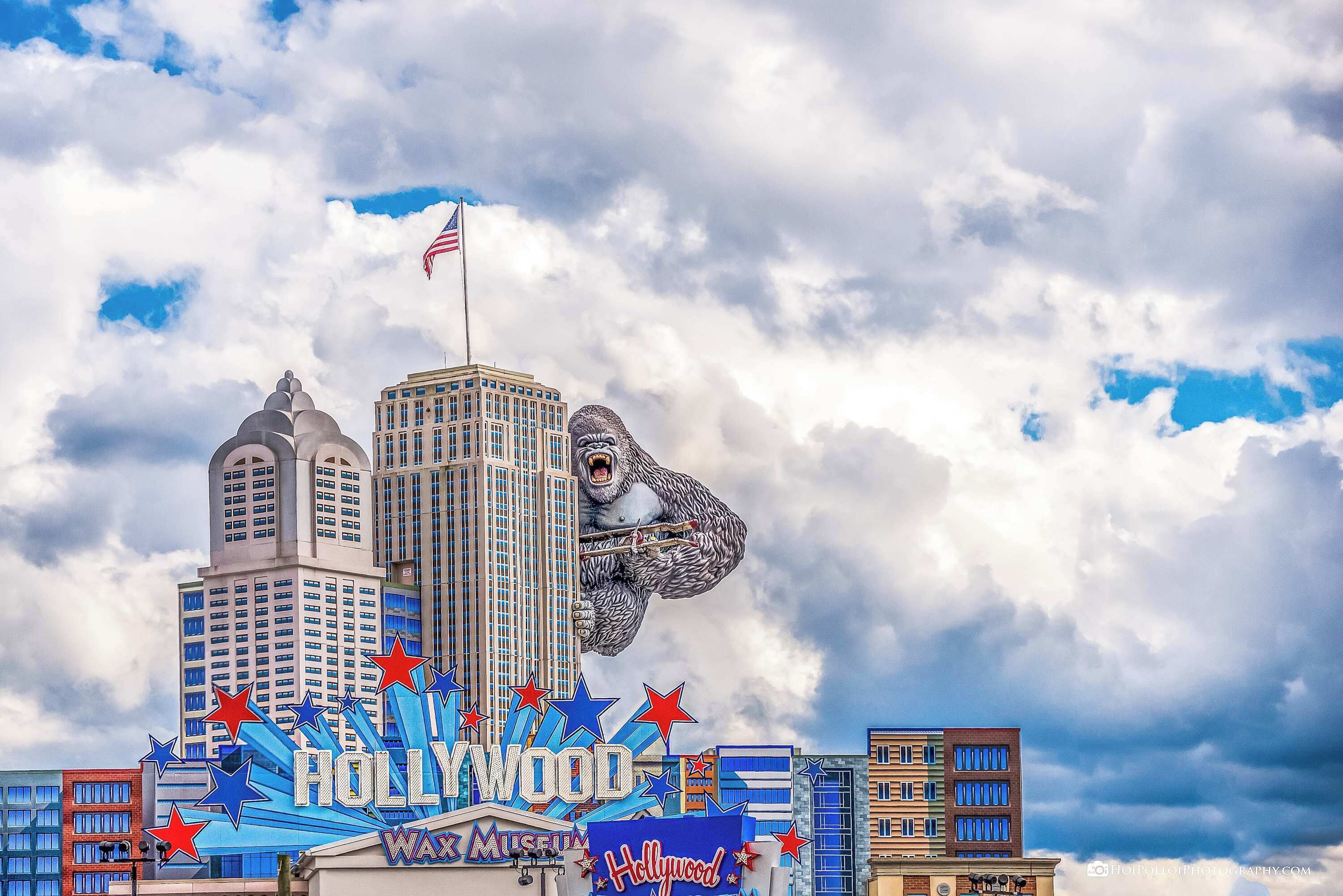 A Hollywood sign with a bear sculpture and a flag.