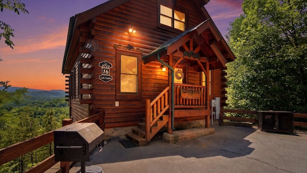 A wooden cabin with a porch, a grill, and a scenic view. - Cabin W Amazing Views・Hot Tub・Shared Sauna - Pool (Pigeon Forge)