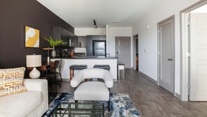 A modern apartment with a living room, kitchen, and dining area. - Landing | Stunning 1BD, Courtyard (Springfield)