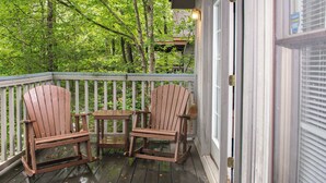A wooden deck with two Adirondack chairs and a small table, surrounded by a white railing. - 4 Mi. to Parkway・Near Dollywood Stay・Hot Tub・Pool (Pigeon Forge)