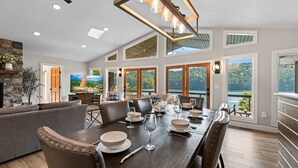 A spacious dining area with a long table set for six, surrounded by comfortable seating.