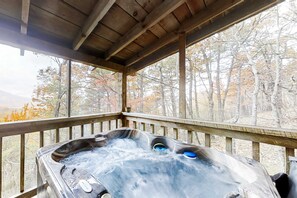 A hot tub on a wooden deck with a view of trees. - Sevierville Smoky Mountain Cabin | Hot Tub & Views (Sevierville)