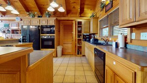 A wooden kitchen with built-in appliances, a tiled floor, and pendant lighting. - Mtn View Cabin, Sleeps 12・Game Room・Hot Tub・Pool (Sevierville)