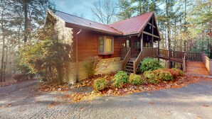 A cabin with a wooden exterior, a metal roof, a wooden staircase, and a porch. - Mtn View Cabin, Sleeps 12・Game Room・Hot Tub・Pool (Sevierville)