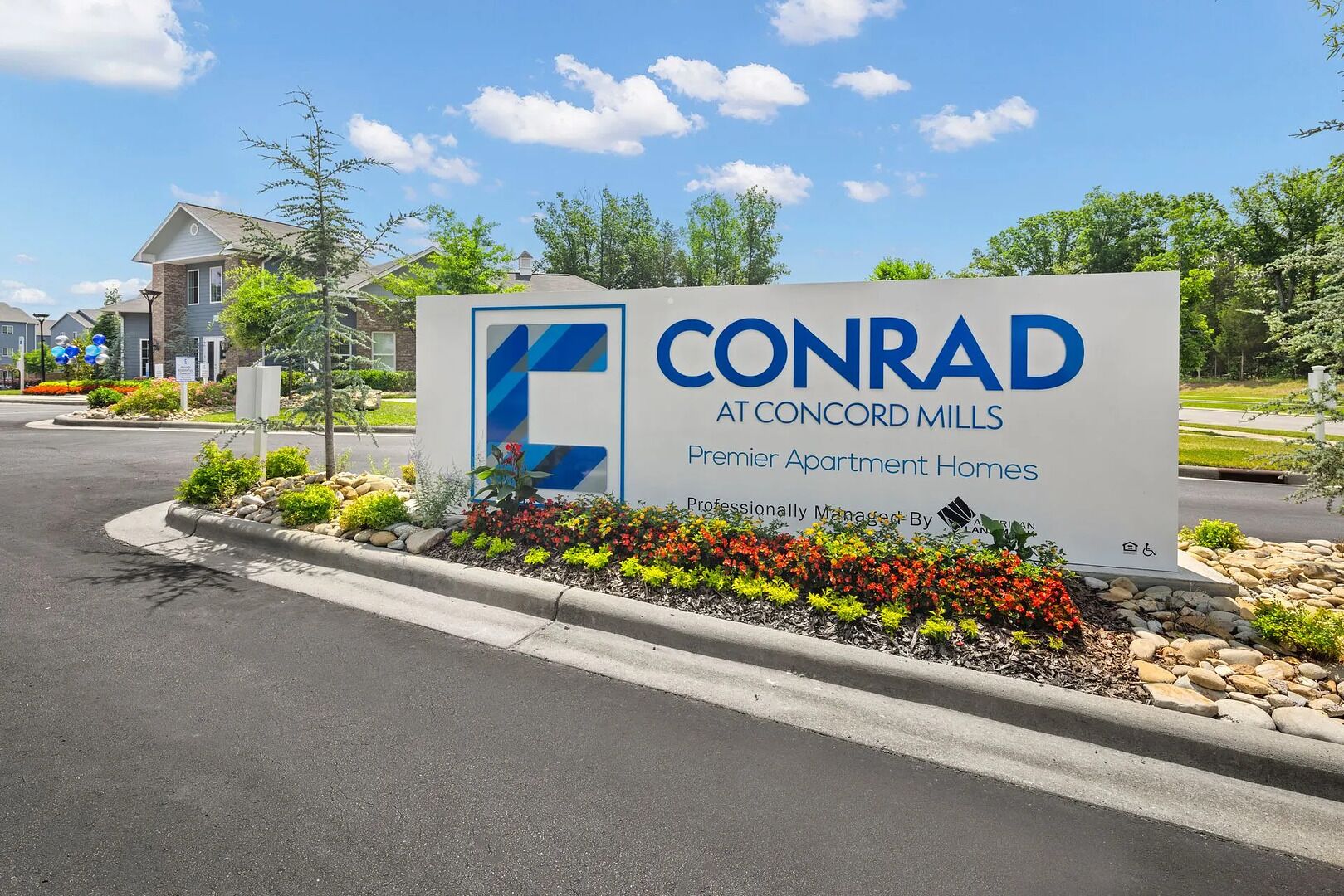 A sign for CONRAD at Concord Mills, indicating it is a premier apartment home.